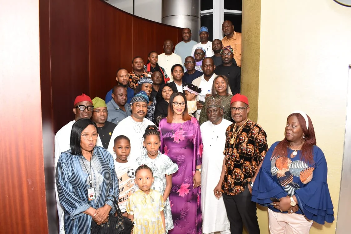 Families and community representatives gathered for a large group portrait