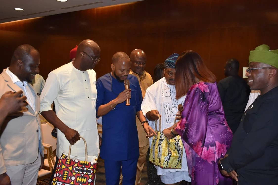 Community representatives gathered around a gift presentation