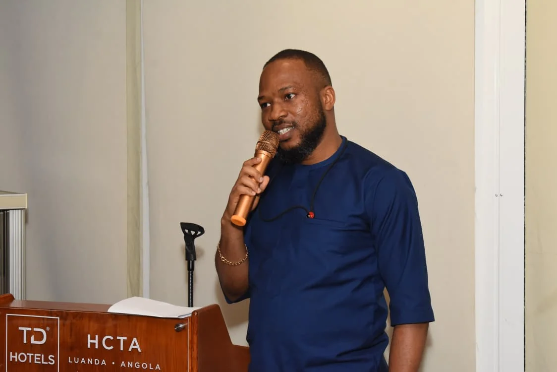 Community representative speaking into a microphone at a lectern