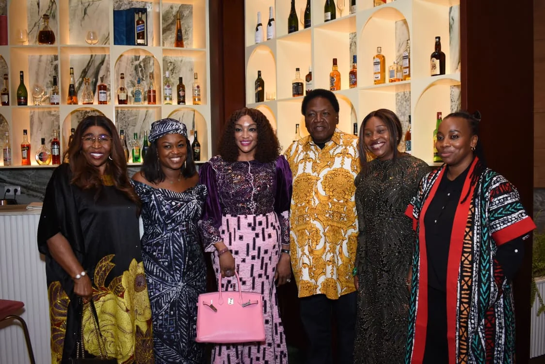 Women and community members posing together in a hotel lounge