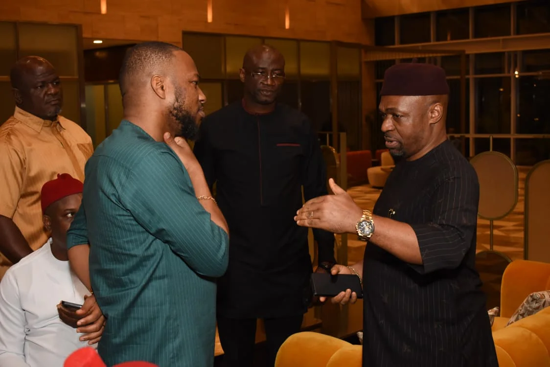 Three community members in conversation after the formal programme