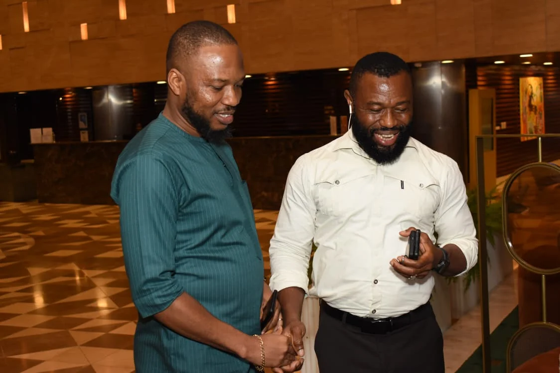 Two guests sharing a light moment in the hotel lobby