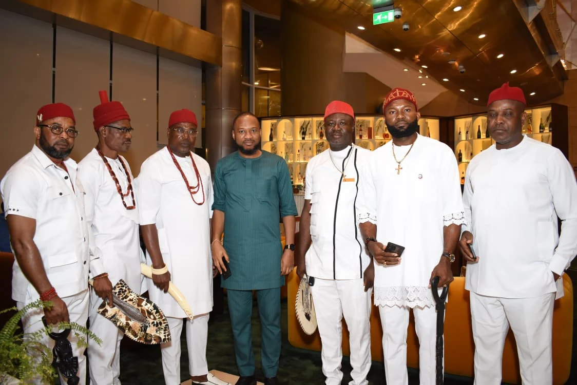 Community representatives in white traditional attire posing together