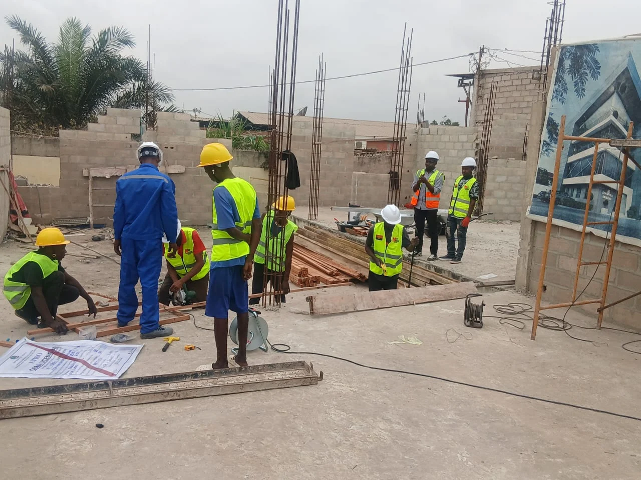 Construction workers in safety vests and helmets working on the proposed Secretariat Complex at Golf 11